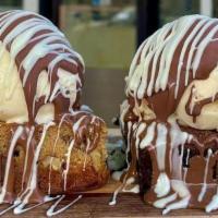 Blondie Brownie Sundae · Two scoops of ice cream, covered in milk chocolate and drizzled with white chocolate. (Blond...