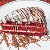 Red Velvet Cake  · Slice of Red Velvet cake , topped with milk chocolate , drizzled with white chocolate.
