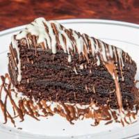 (Cake)  Chocolate Layers · Slice of chocolate layers cake , topped with milk chocolate , drizzled with white chocolate.