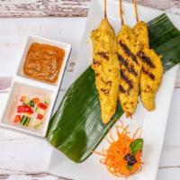 Chicken Satay · Grilled marinated chicken strips on skewers served with peanut sauce and cucumber sauce.