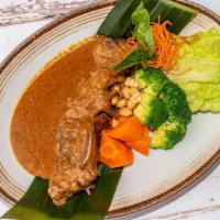 Short Ribs Massaman · Stewed short ribs generously topped with massaman curry sauce and steamed mixed vegetables.