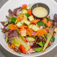 House Salad · Moved greens, cucumbers, tomato, red onion, shaved carrot. Honey balsamic dressing.