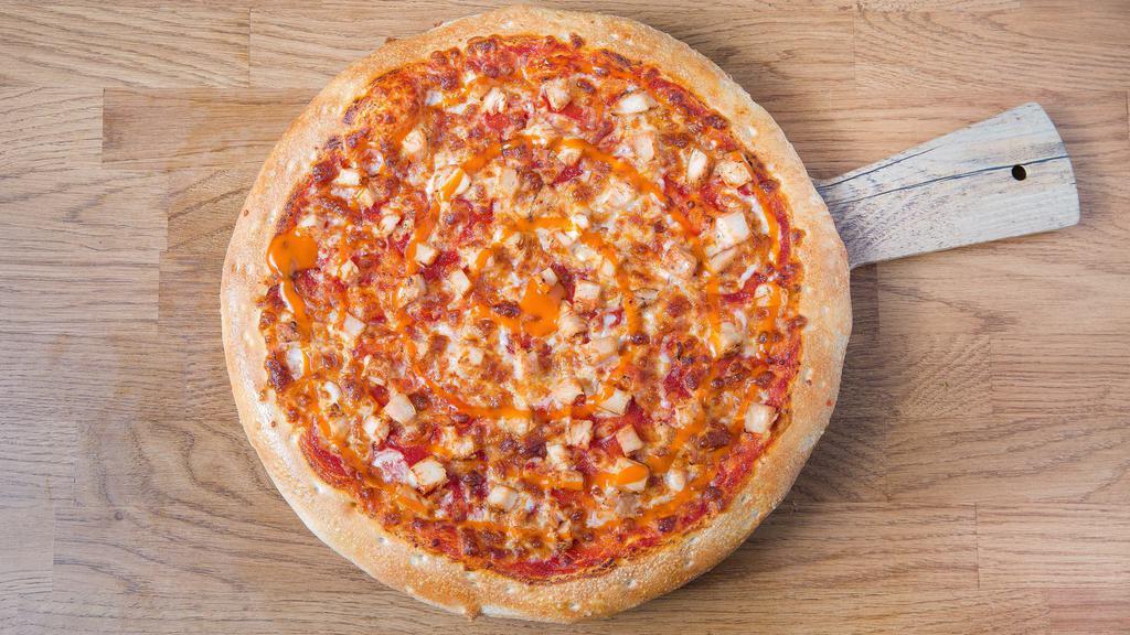Buffalo Chicken Pizza · Features a thin and crispy crust with Buffalo wing sauce topped with diced chicken breast, onions, mozzarella cheese & drizzled with ranch after baking.