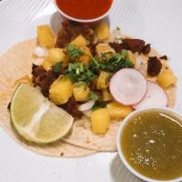 Tacos Al Pastor · Charbroil pork in a soft corn tortilla, chopped onions, grilled pineapple, cilantro and home...