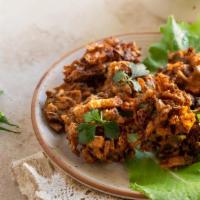 Vegetarian Pakodas · An array of vegetables dipped in a batter of special roasted ground spices and chickpea flou...