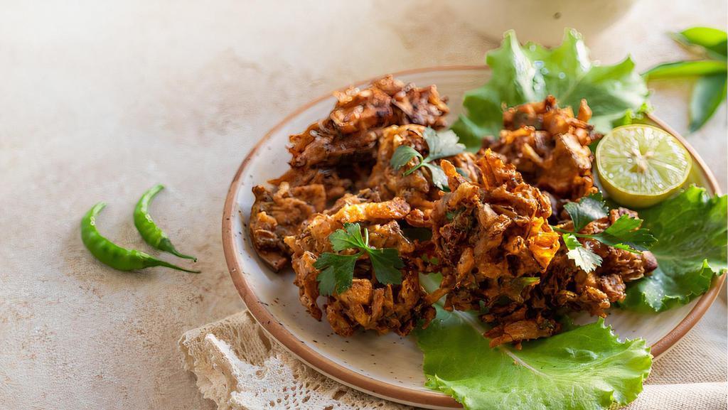 Vegetarian Pakodas · An array of vegetables dipped in a batter of special roasted ground spices and chickpea flour and deep fried.