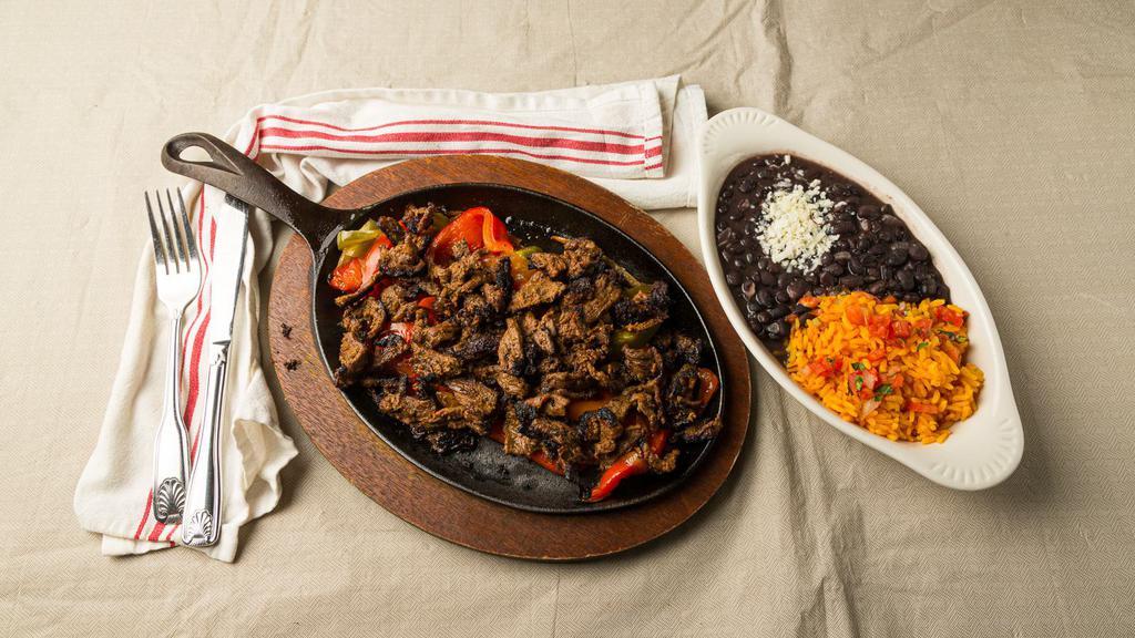 Steak Fajita · with salsa, sour cream, guacamole, rice, black beans, and side of warm corn tortillas.