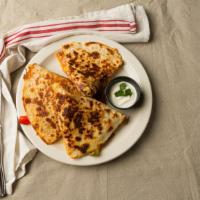 Three Cheese Quesadilla · With sauteed peppers and onions.