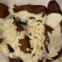 Sweet Plantains · Served with drizzled sour cream and cotija cheese.