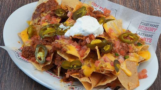 Loaded Nachos · smoked bacon chili, cheddar cheese, sour cream, jalapeno