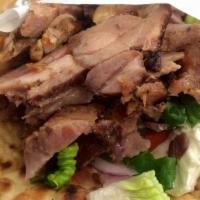 Gyro Sandwich · Succulent pork meat served in pita bread with tzatziki and vegetables. Served with lettuce, ...