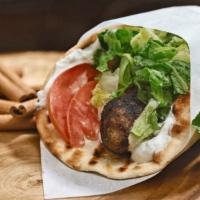 Brizolaki Sandwich · Pork belly in pita bread with tzatziki sauce. Served with lettuce, tomatoes and onions.