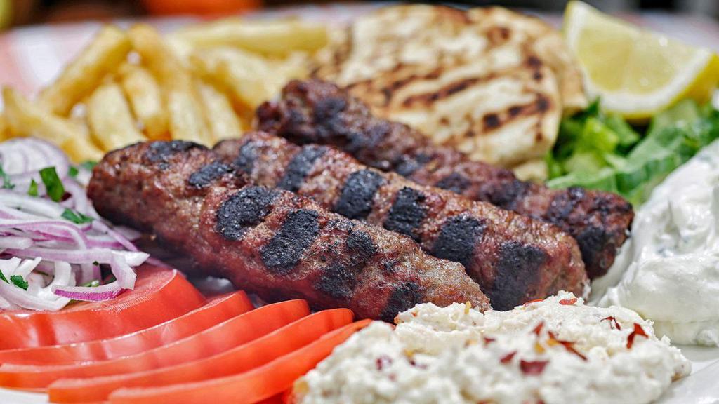 Beef Kebob Platter · Ground beef and lamb charcoal grilled (3), served with lettuce, tomatoes, onions, tzatziki,pita and choice of side.