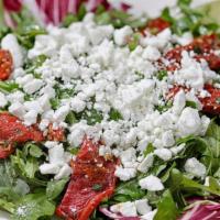 Arugula Salad · Arugula, sun-dried tomatoes and crumbled goat cheese garnished with endive, radicchio tossed...