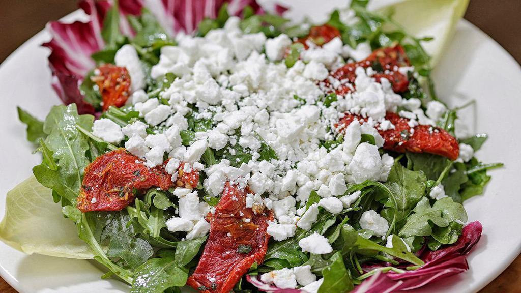 Arugula Salad · Arugula, sun-dried tomatoes and crumbled goat cheese garnished with endive, radicchio tossed in homemade honey vinaigrette dressing.