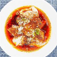 Poached Wontons In Chili Sauce. · Pork, pepper and sesame. Served spicy.