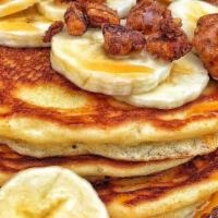 Famous Banana Stack Breakfast · 3 buttermilk pancakes topped with fresh bananas, pecans and caramel drizzle.