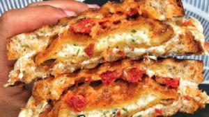 The Marco Panini · Fried cheese ravioli, sun-dried tomato and marinara sauce with melted Mozzarella. Served on ...