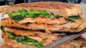 The How U Doin Panini · Grilled chicken, broccoli rabe with garlic and oil, smoked Mozzarella and roasted pepper dre...