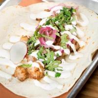 Shrimp Taco · Pickled onion, cilantro, and crema.