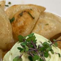 Potato Perogies · sour cream and caramelized onions.