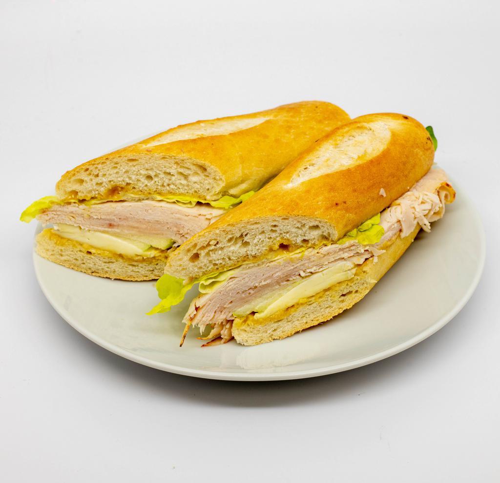 Turkey Brie & Apple Ficelle · Turkey, Brie cheese, granny smith apple, honey mustard and green leaf lettuce on a ficelle.
