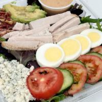 Classic Cobb Salad · Roasted chicken, shredded cheddar cheese, blue cheese crumbles, black olives, hard boiled eg...