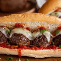 Meatball Parm Hero Sandwich · Delicious juicy meatballs with parmesan cheese topped with marinara sauce and house sauce.