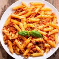 Rigatoni Bolognese · Al dente, ridged pasta tubes, served with a heart bolognese meat sauce.