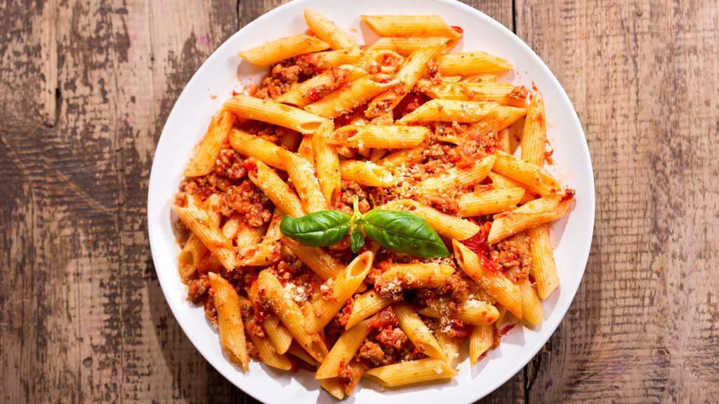 Rigatoni Bolognese · Al dente, ridged pasta tubes, served with a heart bolognese meat sauce.