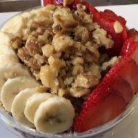 Classic Acai Bowl · Acai, topped with banana, granola, shredded coconut, chia seeds, and honey.