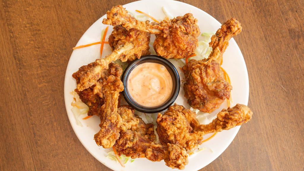 Lolly Pop Chicken · Pulled back chicken wings battered and fried to golden perfection served with a creamy sauce.