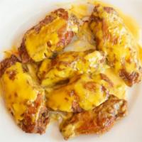Spicy Mango Wings · Spicy fried wings mix with mango flavored sauce. Hot and spicy.