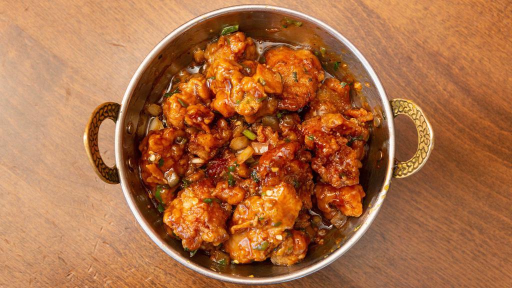 Chili Chicken · Batter fried chicken cube in a Manchurian sauce, onion & green chili. Hot and spicy.