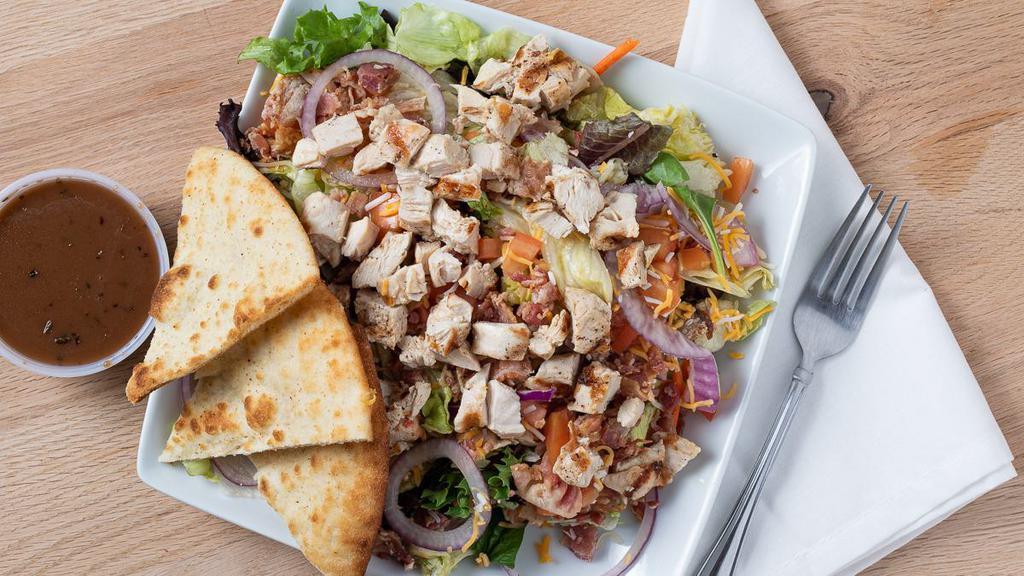 Chicken Blt Salad · Mixed greens topped with charbroiled chicken breast, fresh bacon pieces, chopped tomatoes, purple onions, and shredded cheddar cheese, served with ranch dressing and pita points.