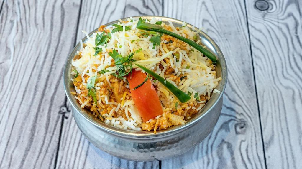 Chicken Biryani · Basmati rice saffron flavored, sealed with Chicken and cooked on slow fire to seal the flavors in.