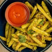 Chutney Fries (Vegan) · Fries tossed in a Mint/Cilantro Sauce served with Spicy Ketchup