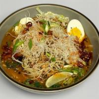Chicken Khao Suey · Coconut Curry Broth, Egg noodles, Peanuts, Pickled Vegetables, Jammy Egg and Fried Vermicelli.
