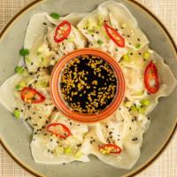 Chicken Momos · Chicken stuffed dumplings served with soy and chili sauce