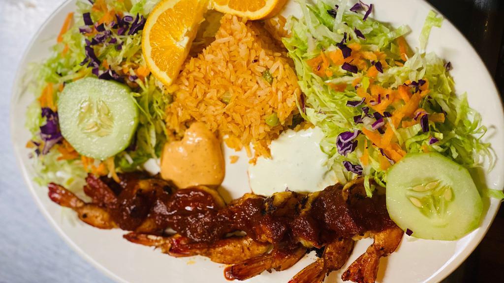 Camarones A La Diabla · Shrimp devil. served with spicy red sauce, white rice, salad (shredded carrots, lettuce, cucumbers, shredded red cabbage)
