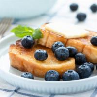 Blueberry French Toast · Two fluffy, delicious challah bread French toast slices with fresh blueberries, served with ...