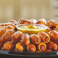Mini Dogs & Rivets Party Tray · A winning pair: 36 all beef mini pretzel dogs with American cheese and 64 bite-sized rivets,...