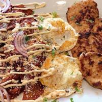 Chilaquiles  · Fried tortillas in green (mild) or red salsa (spicy) and has cheese, Mexican sour cream and ...