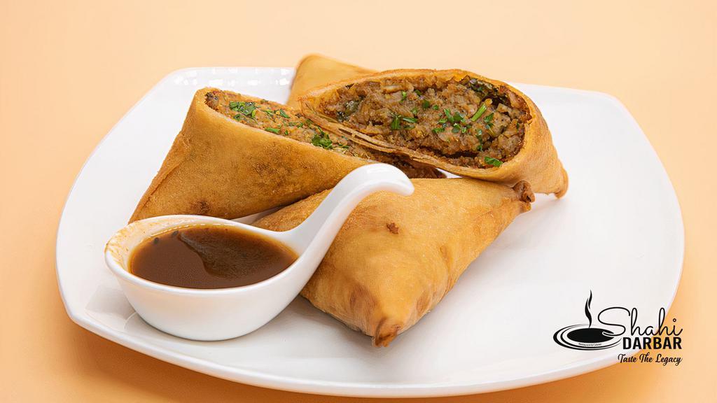 Chicken Samosa · Deep fried crispy, triangular pastry filled with aromatic chicken and peas filling served with a sauce of your choice. A hearty snack for your starving stomach.