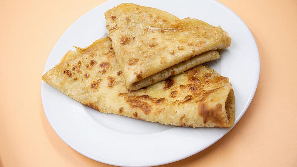 Parata · Another popular flat-bread. Round in shape and fried with ghee (clarifying butter) for richness.