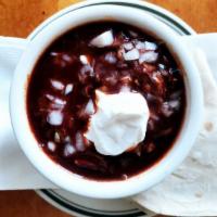 Cup Of Chili Colorado · Shredded beef cooked in red chili. Sour cream & onion on request.