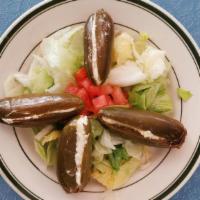 Stuffed Jalapeno Salad · Spicy pickled jalapenos filled with cream cheese on a bed of lettuce.