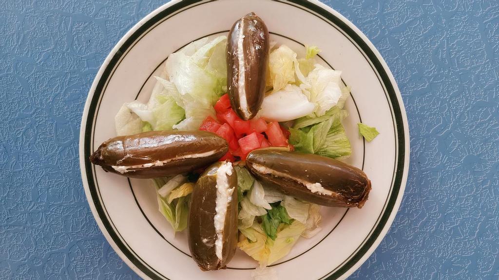 Stuffed Jalapeno Salad · Spicy pickled jalapenos filled with cream cheese on a bed of lettuce.