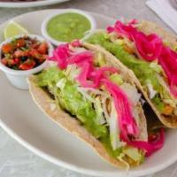 Fried Flounder Tacos · Fried flounder in corn tortillas , served with pico de gallo and a creamy avocado sauce. Com...