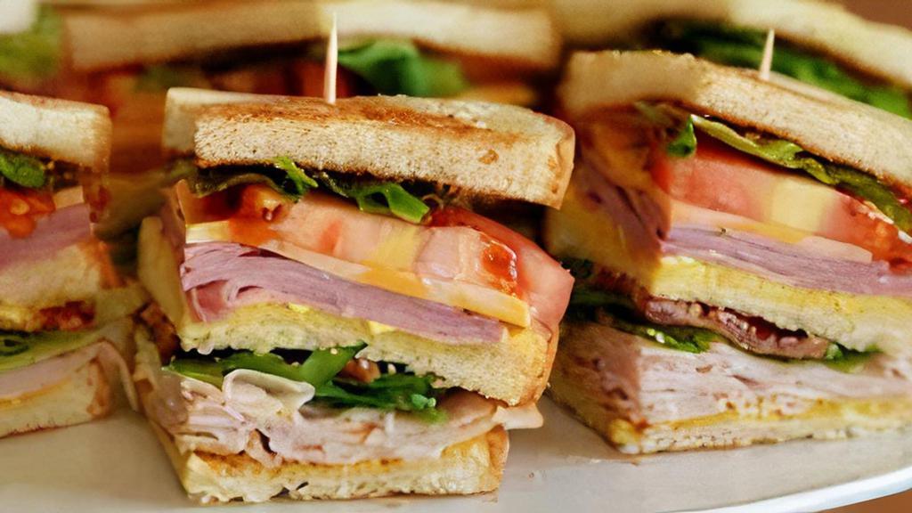 Club Sandwich · Ham, american cheese, turkey/swiss cheese, lettuce, tomatoes, bacon, mayo.